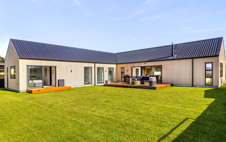 Exterior vertical shiplap cladding on barn-style home