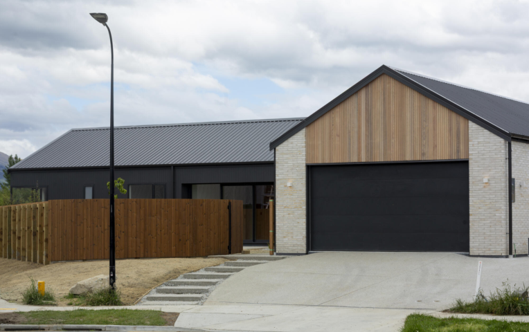 Exterior view of Jack's Point Queenstown Home with Western Red Cedar cladding and TMT Taiga fencing