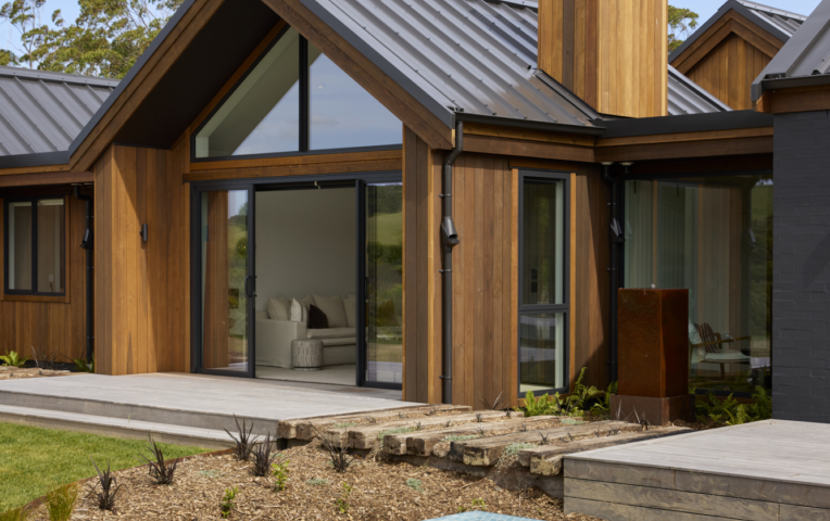 Exterior of Palliser Downs Showhome and pool with JSC's TMT Taxon vertical shiplap cladding
