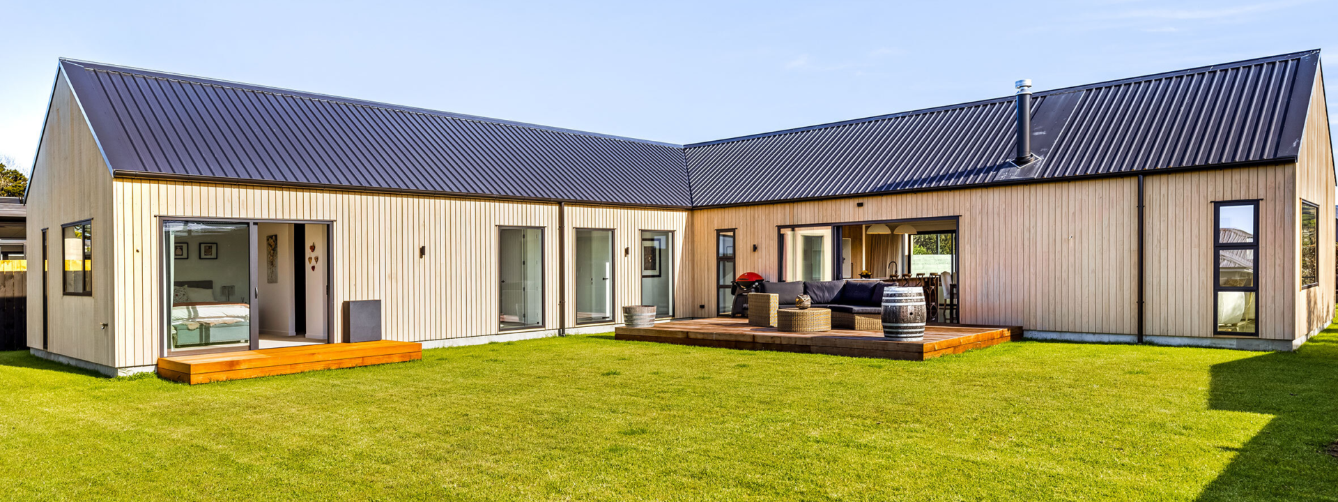 Exterior vertical shiplap cladding on barn-style home