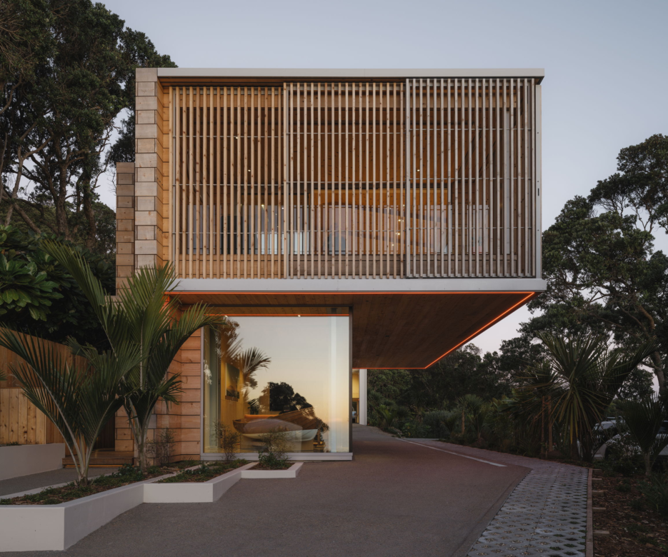 Exterior view of Muriwai home with rustic cedar cladding and battens & screens