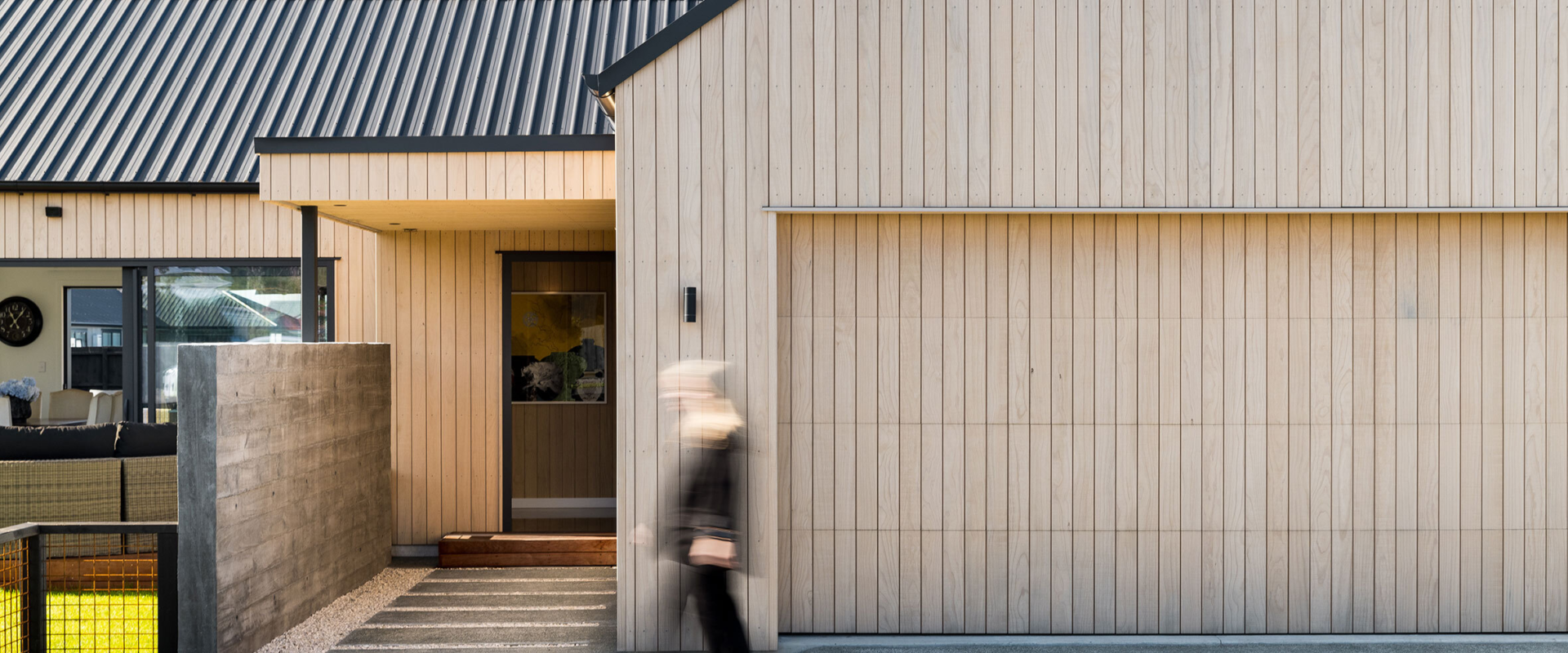 Exterior detail of radiata pine vertical shiplap cladding on contemporary barn-style home